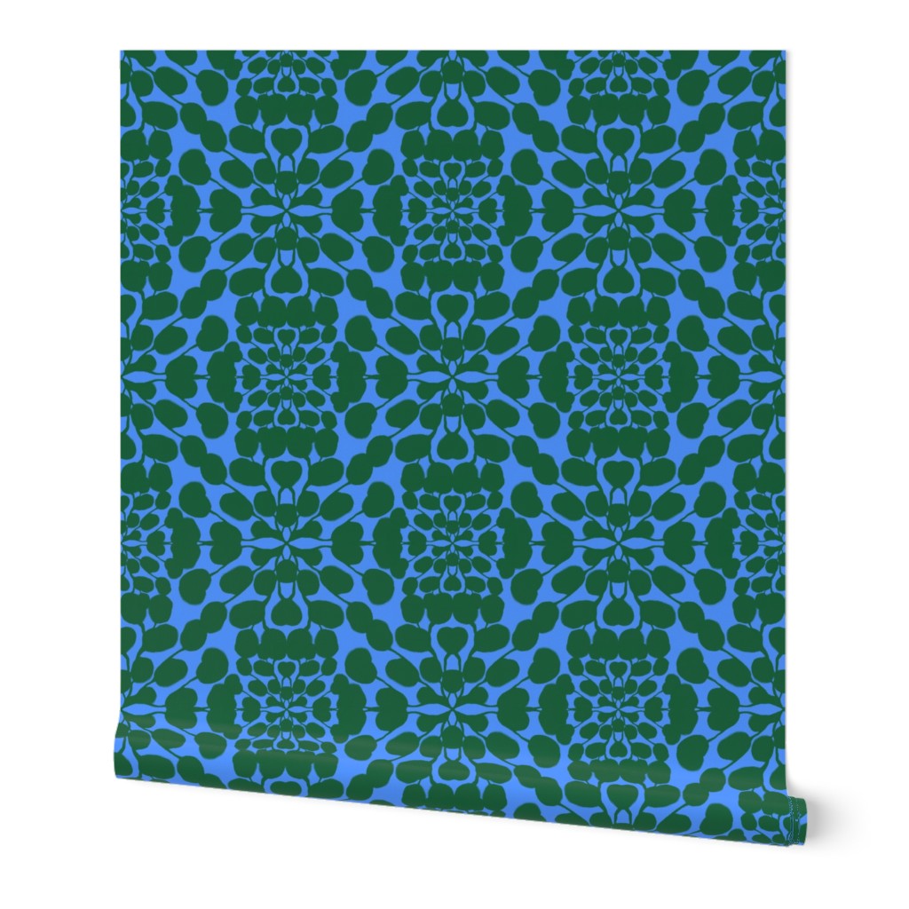 Blue roll of wallpaper with green floral pattern on a white background. Designed by artist Leila Simon Hayes.