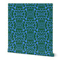 Blue roll of wallpaper with green floral pattern on a white background. Designed by artist Leila Simon Hayes.
