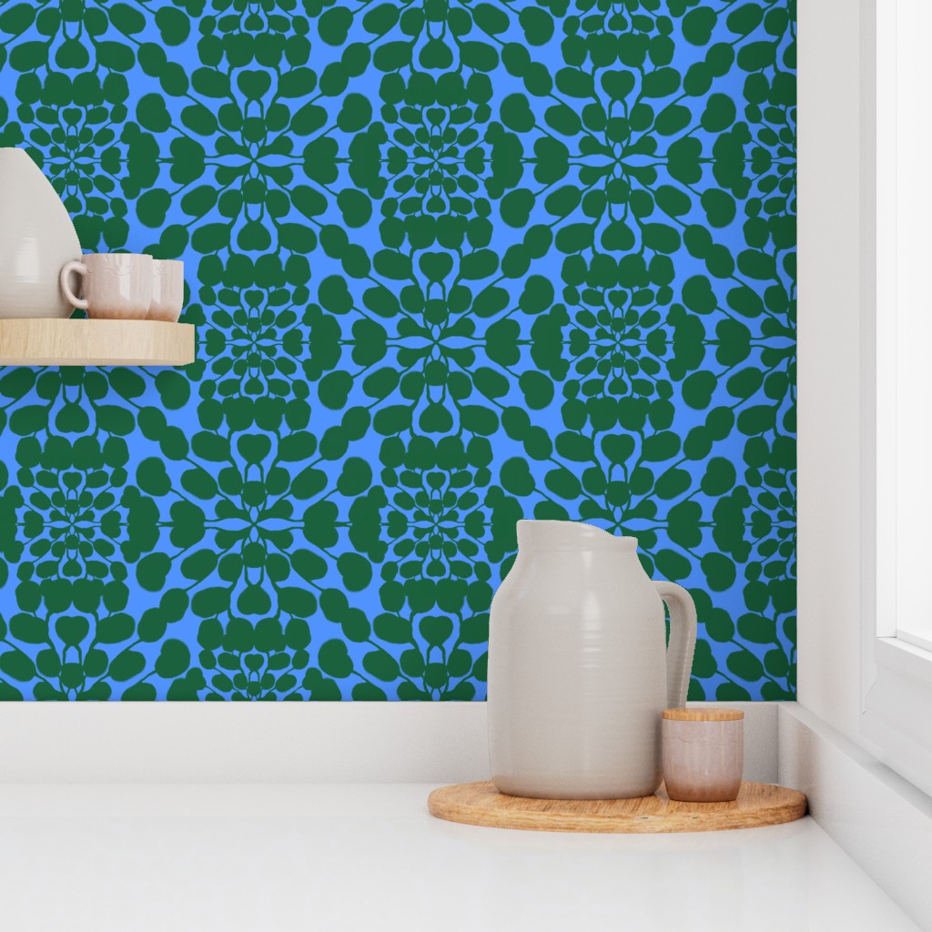 Decorative wallpaper with green leaf pattern on a blue background, featuring ceramic pitchers and cups. Designed by artist Leila Simon Hayes.
