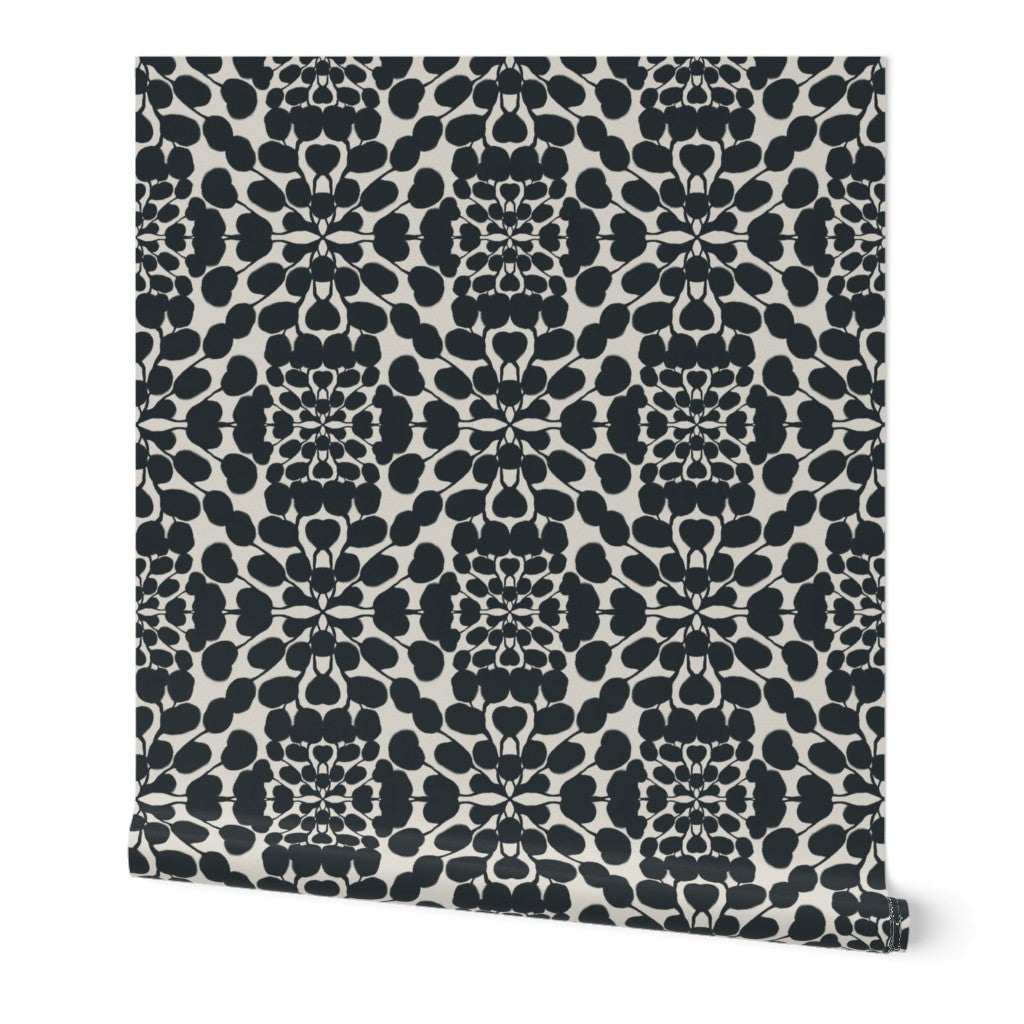 Black and white patterned roll of wallpaper on a white background. Designed by artist Leila Simon Hayes.