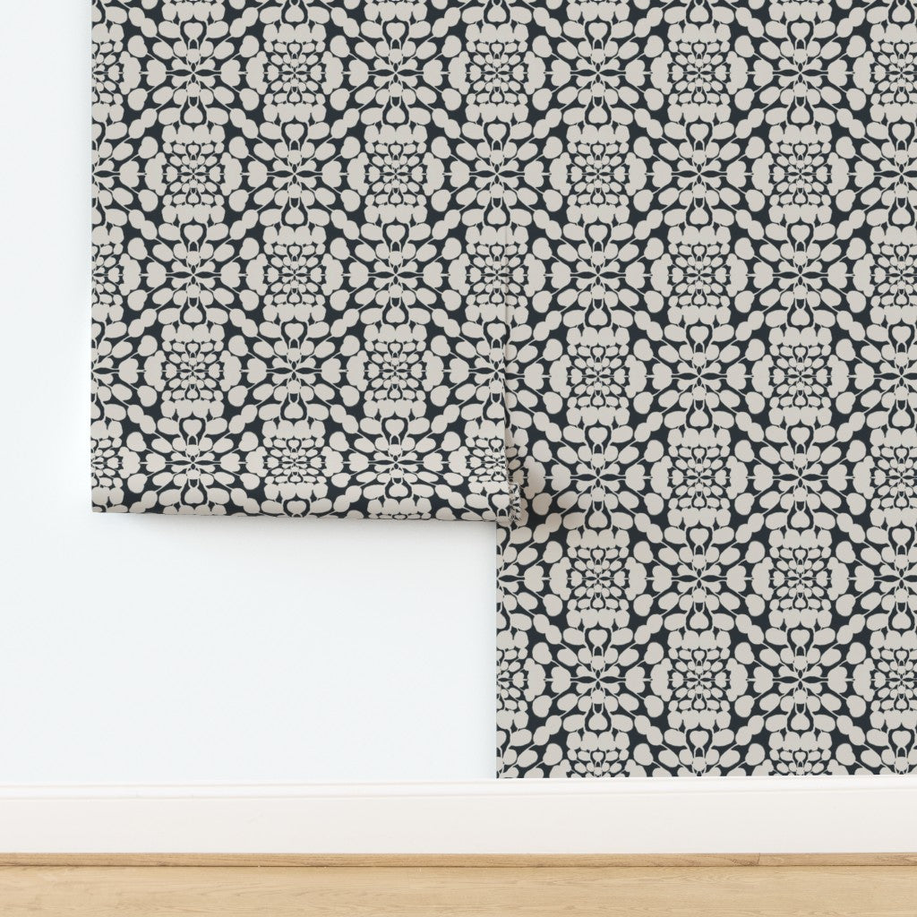 Roll of patterned wallpaper with a geometric design on a white background. Designed by artist Leila Simon Hayes. 