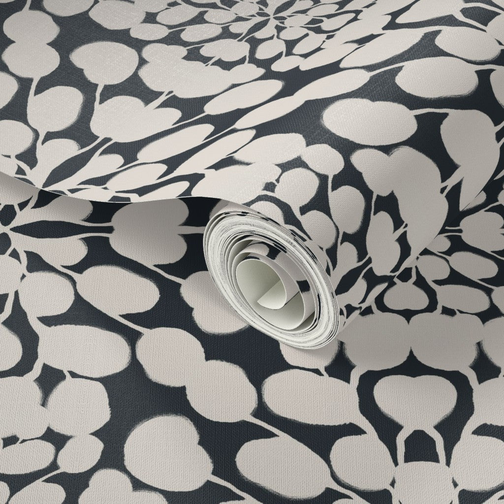 Roll of wallpaper with a black and white floral pattern. Designed by artist Leila Simon Hayes. 