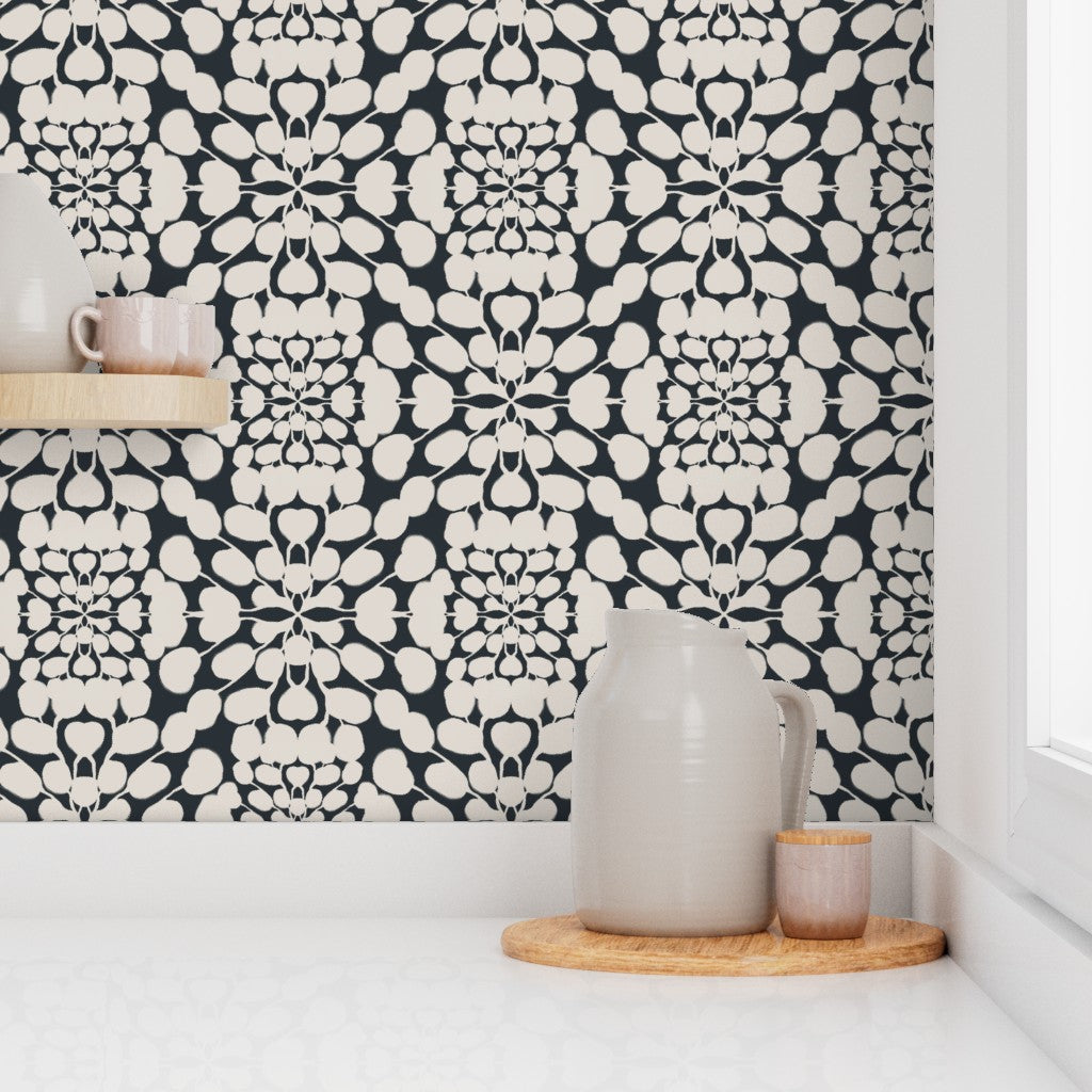 Kitchen setting with a black and white patterned wall and ceramic items on a shelf. Designed by artist Leila Simon Hayes. 