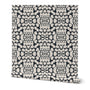 Roll of wallpaper with a black and white pattern on a white background. Designed by artist Leila Simon Hayes. 