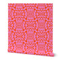 Pink geometric pattern on orange fabric. Designed by artist Leila Simon Hayes. 