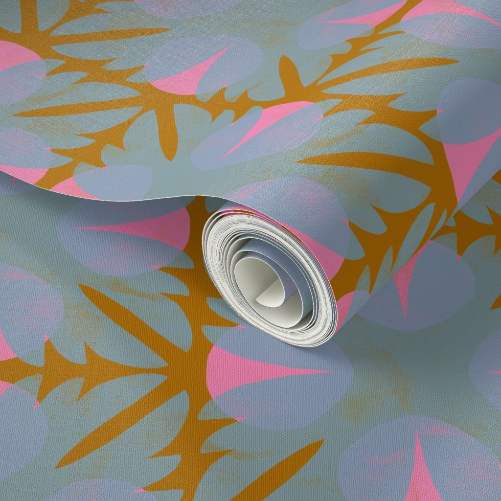 Roll of wallpaper with a colorful abstract pattern on a light blue background. Designed by artist Leila Simon Hayes 
