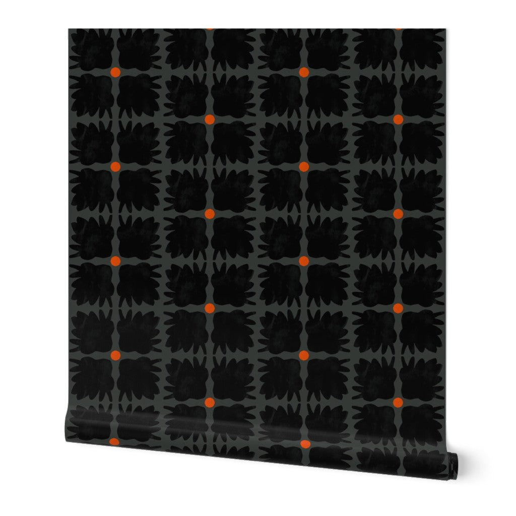 Roll of wallpaper with black abstract pattern and orange dots on a white background. Designed by artist Leila Simon Hayes.