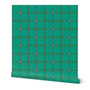 A green roll of wallpaper with a grid pattern on a white background. Designed by artist Leila Simon Hayes.