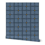 Patterned roll of blue wallpaper with yellow accent circles on a white background. Designed by artist Leila Simon Hayes.