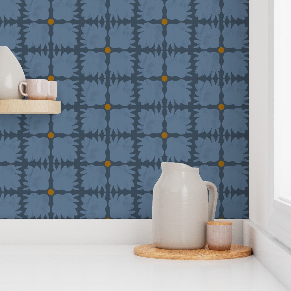 White ceramic pitcher and small cup on a wooden tray against a blue patterned wall. Designed by artist Leila Simon Hayes.
