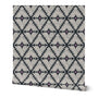 Roll of wallpaper with a geometric pattern on a white background. Designed by artist Leila Simon Hayes.