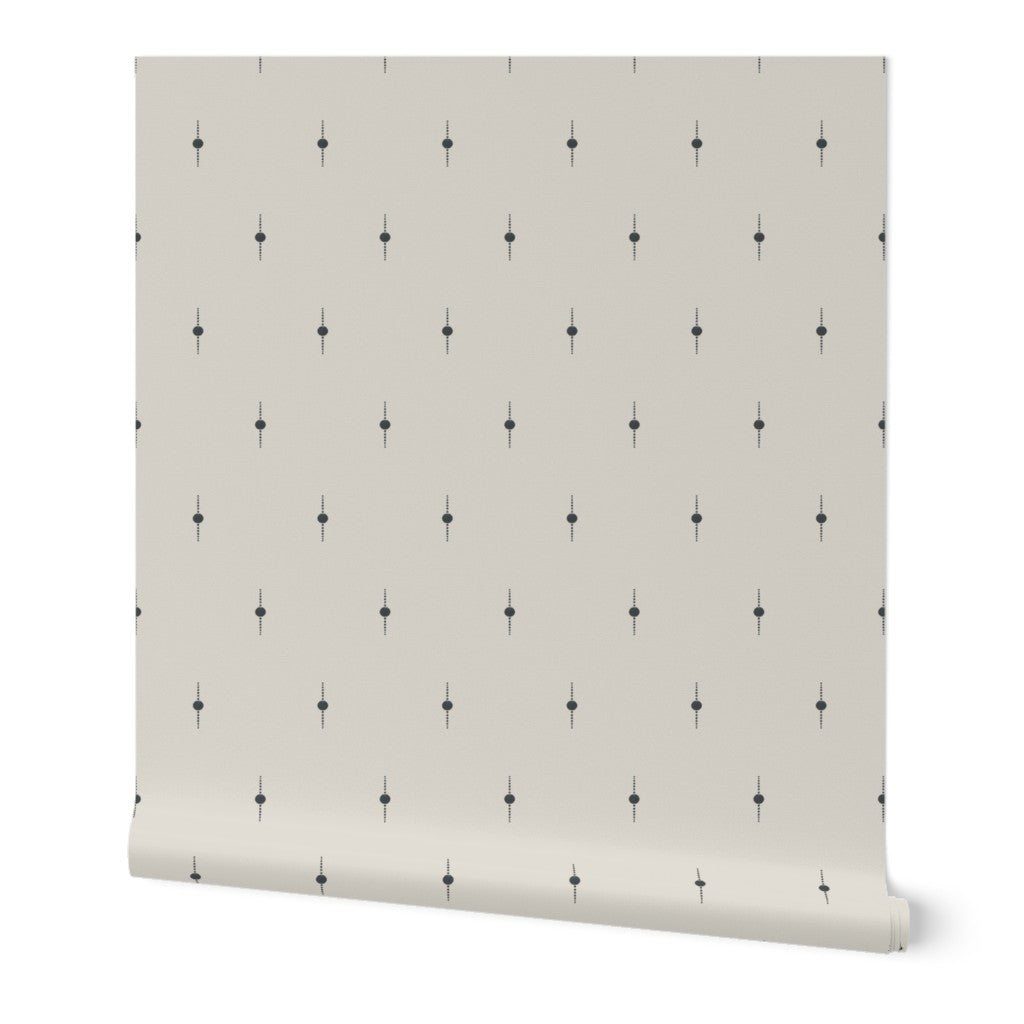 Roll of white wallpaper with a subtle black geometric star pattern on a white background. Designed by artist Leila Simon Hayes. 