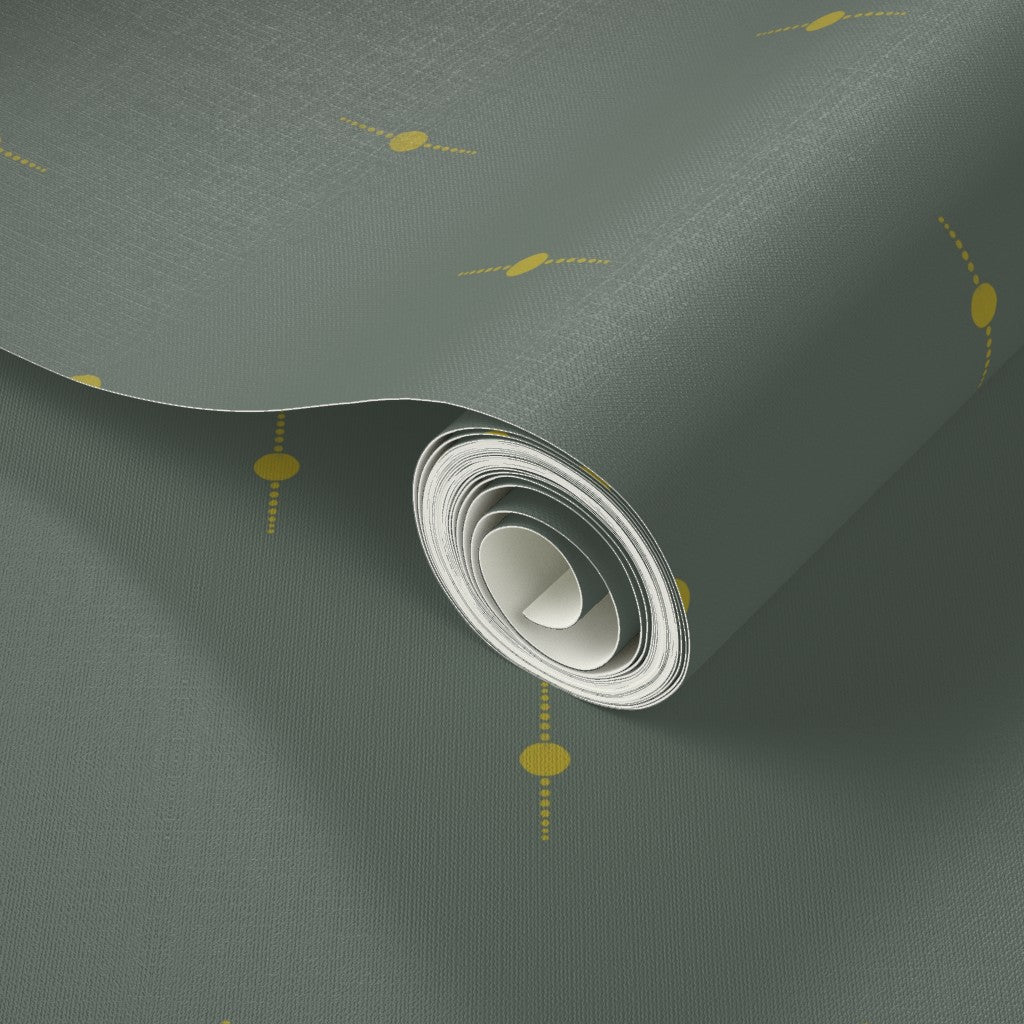 Roll of olive green wallpaper with a textured surface and small yellow geometric star elements. Designed by artist Leila Simon Hayes. 