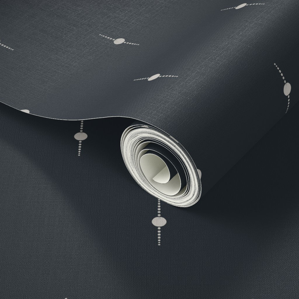 Close-up of a black and white wallpaper roll with small geometric star patterns. Designed by artist Leila Simon Hayes. 