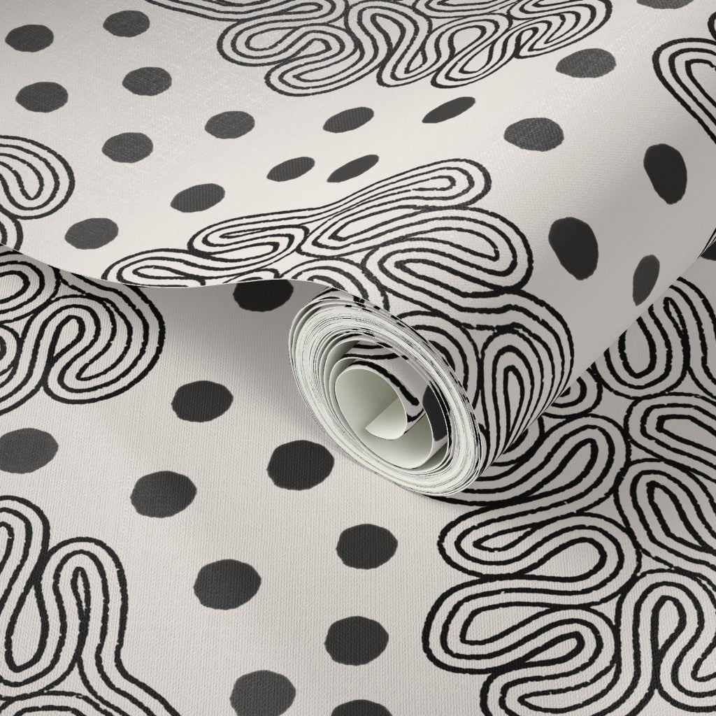 Roll of wallpaper with black abstract patterns on a white background. Designed by artist Leila Simon Hayes. 