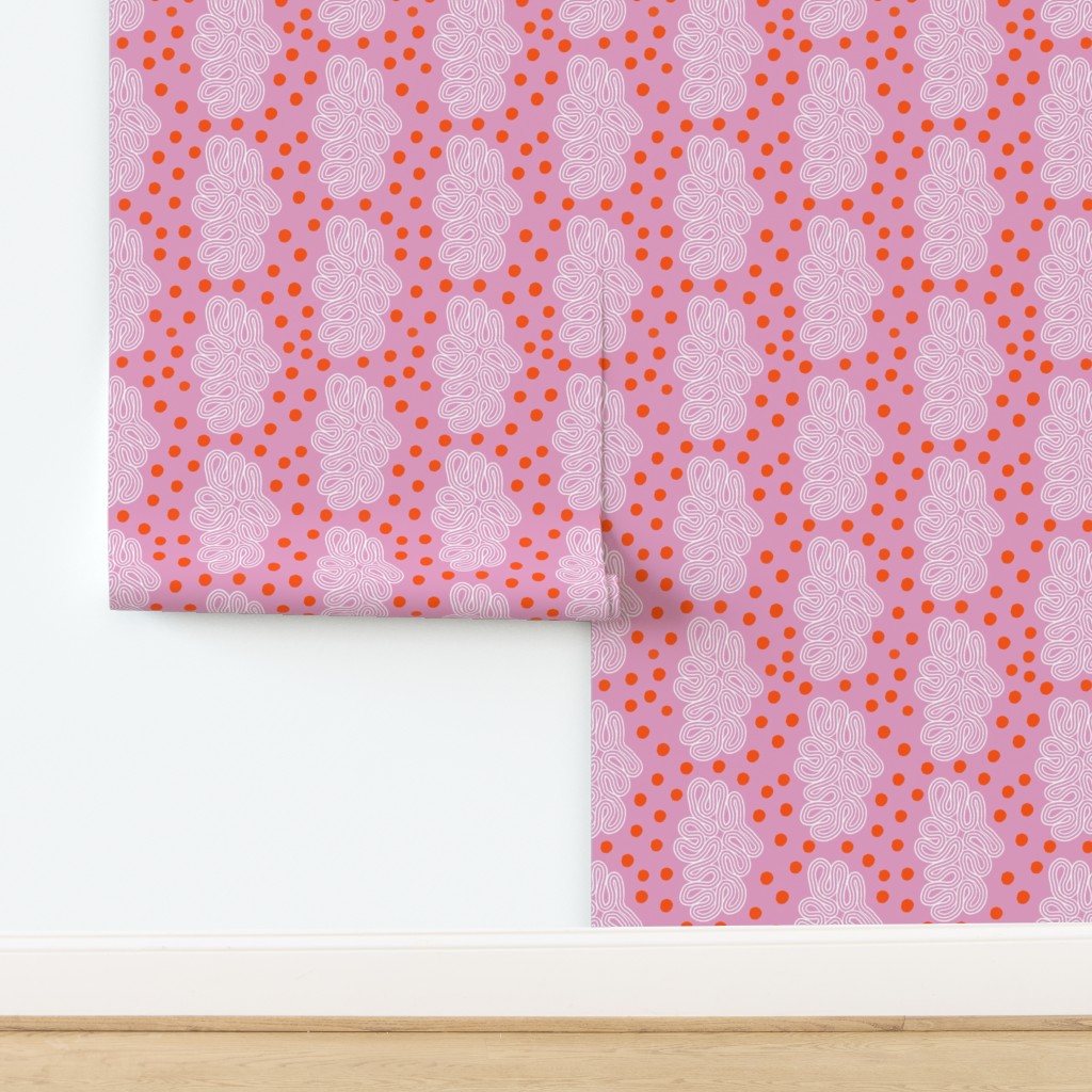 Roll of pink wallpaper with red geometric pattern on a white background. Designed by artist Leila Simon Hayes. 