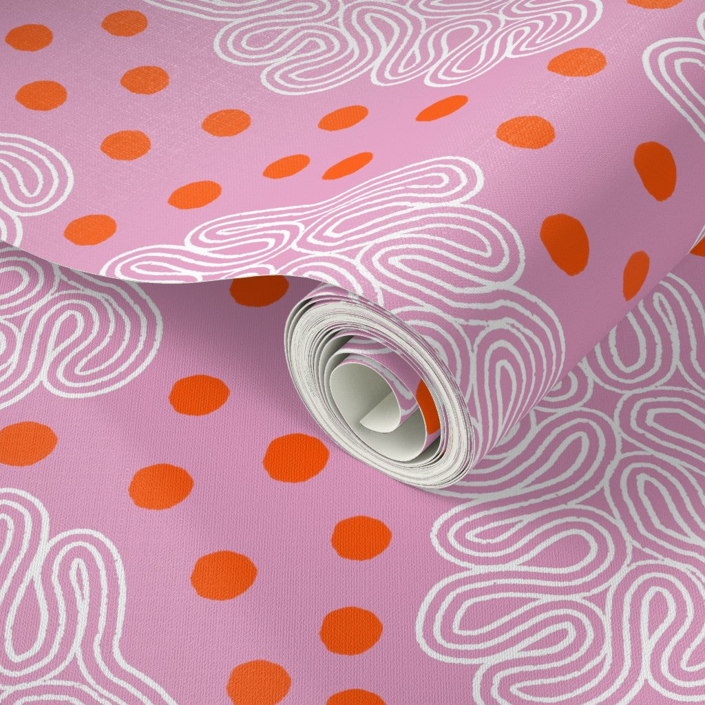 Roll of pink paper with orange polka dots and white wavy lines. Designed by artist Leila Simon Hayes. 