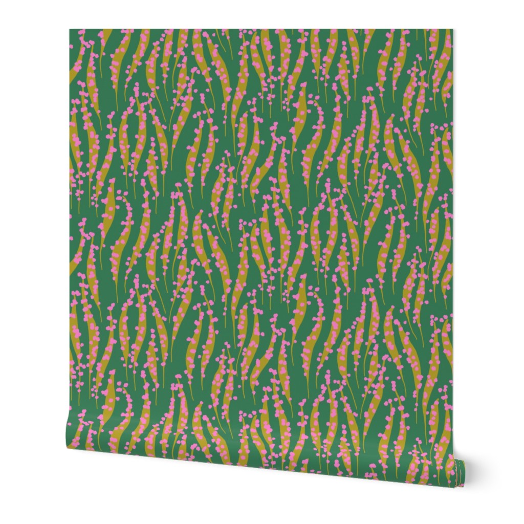Roll of wallpaper with a green and pink wavy pattern. Designed by artist Leila Simon Hayes.