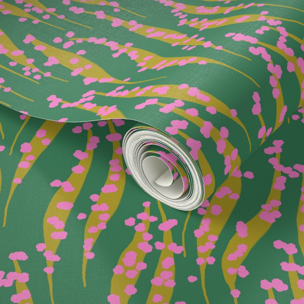 Roll of green paper with pink and yellow abstract pattern. Designed by artist Leila Simon Hayes. 