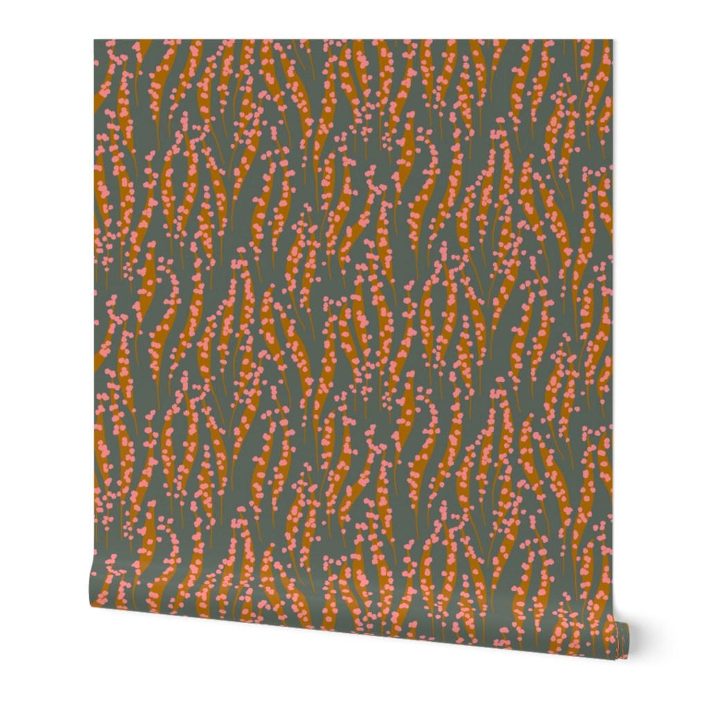 Wallpaper with a pattern of wavy lines in orange and pink on a dark green background. Designed by artist Leila Simon Hayes. 
