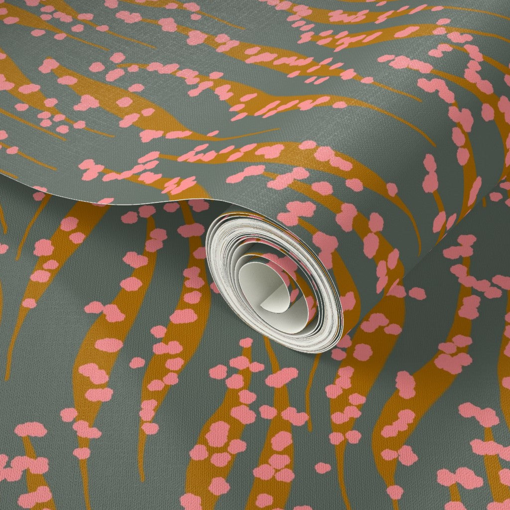 Roll of wallpaper with pink floral pattern on a dark background. Designed by artist Leila Simon Hayes. 