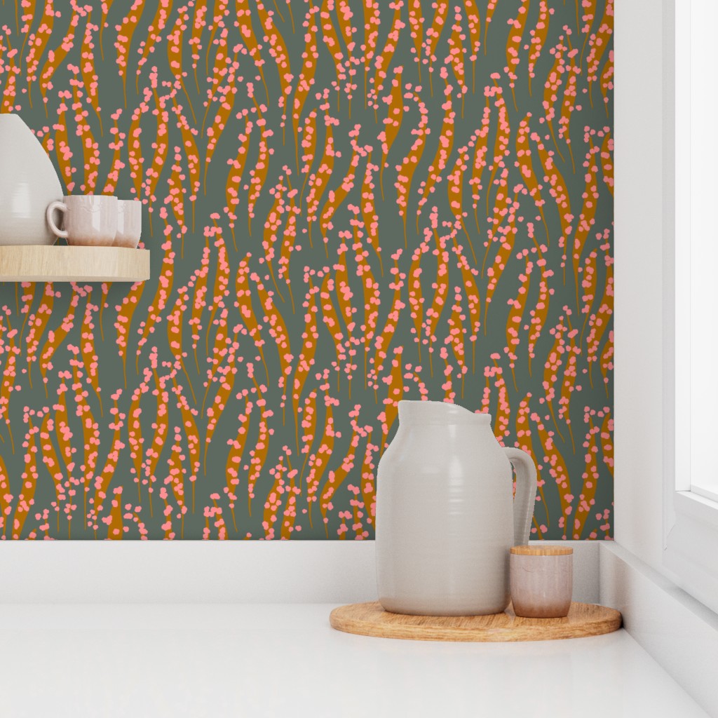Decorative wallpaper with a floral pattern in orange and pink on a green background, featuring ceramic pitchers and a cup on a shelf. Designed by artist Leila Simon Hayes. 