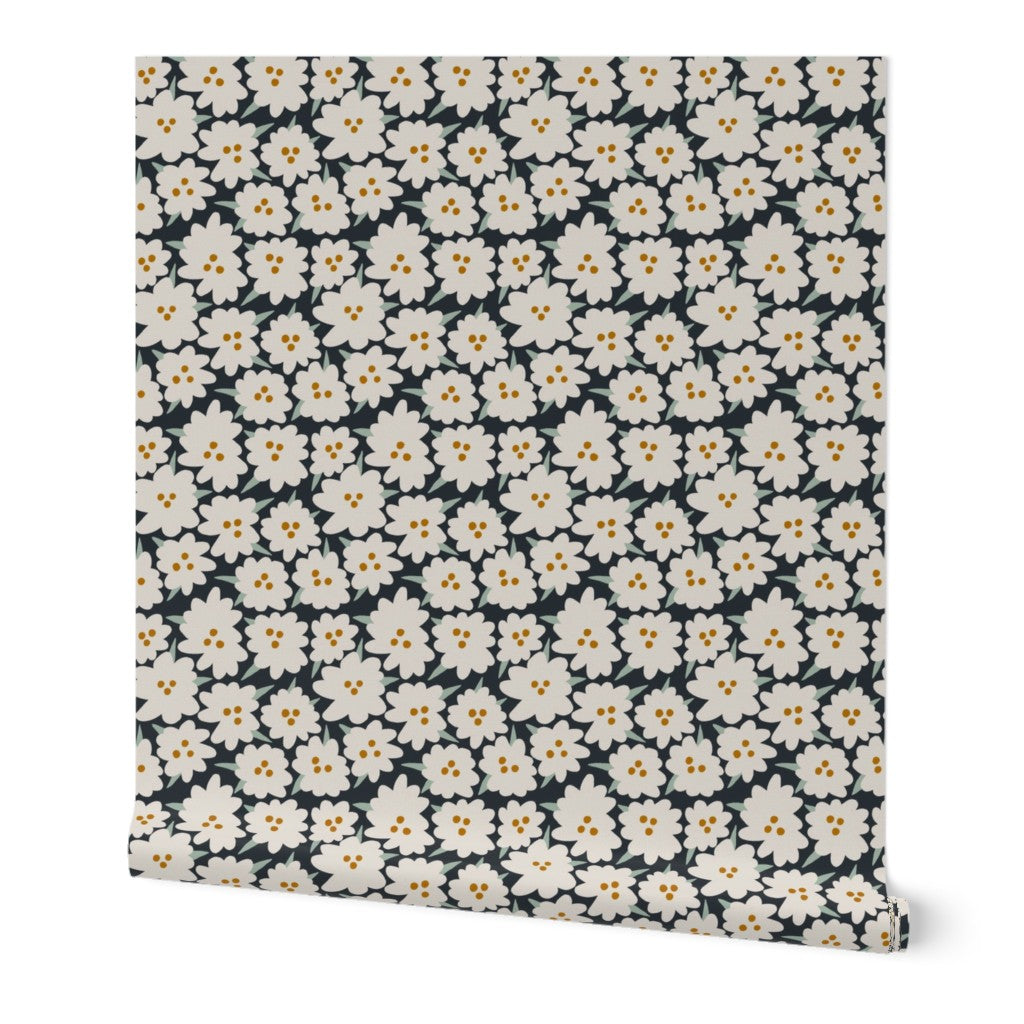 Floral patterned roll of wallpaper with white flowers on a dark background. Designed by artist Leila Simon Hayes.
