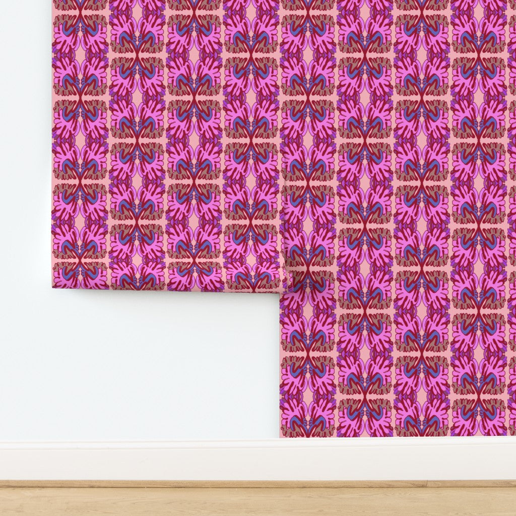 Roll of pink and purple patterned wallpaper on a white background. Designed by artist Leila Simon Hayes.
