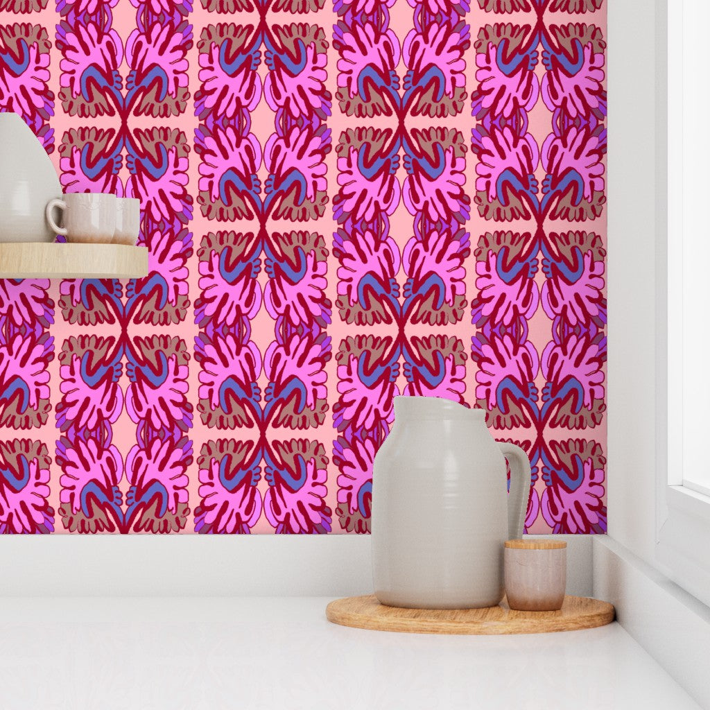 Ceramic pitcher and small container on a wooden tray against a pink and purple patterned wall. Designed by artist Leila Simon Hayes.