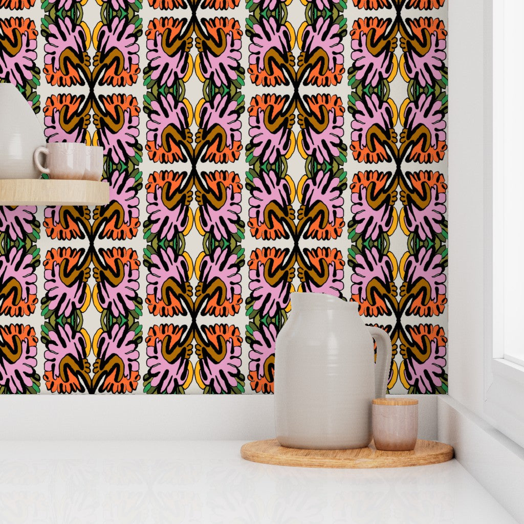 Colorful abstract patterned curtain in a room with a white wall and wooden shelf. Designed by artist Leila Simon Hayes.