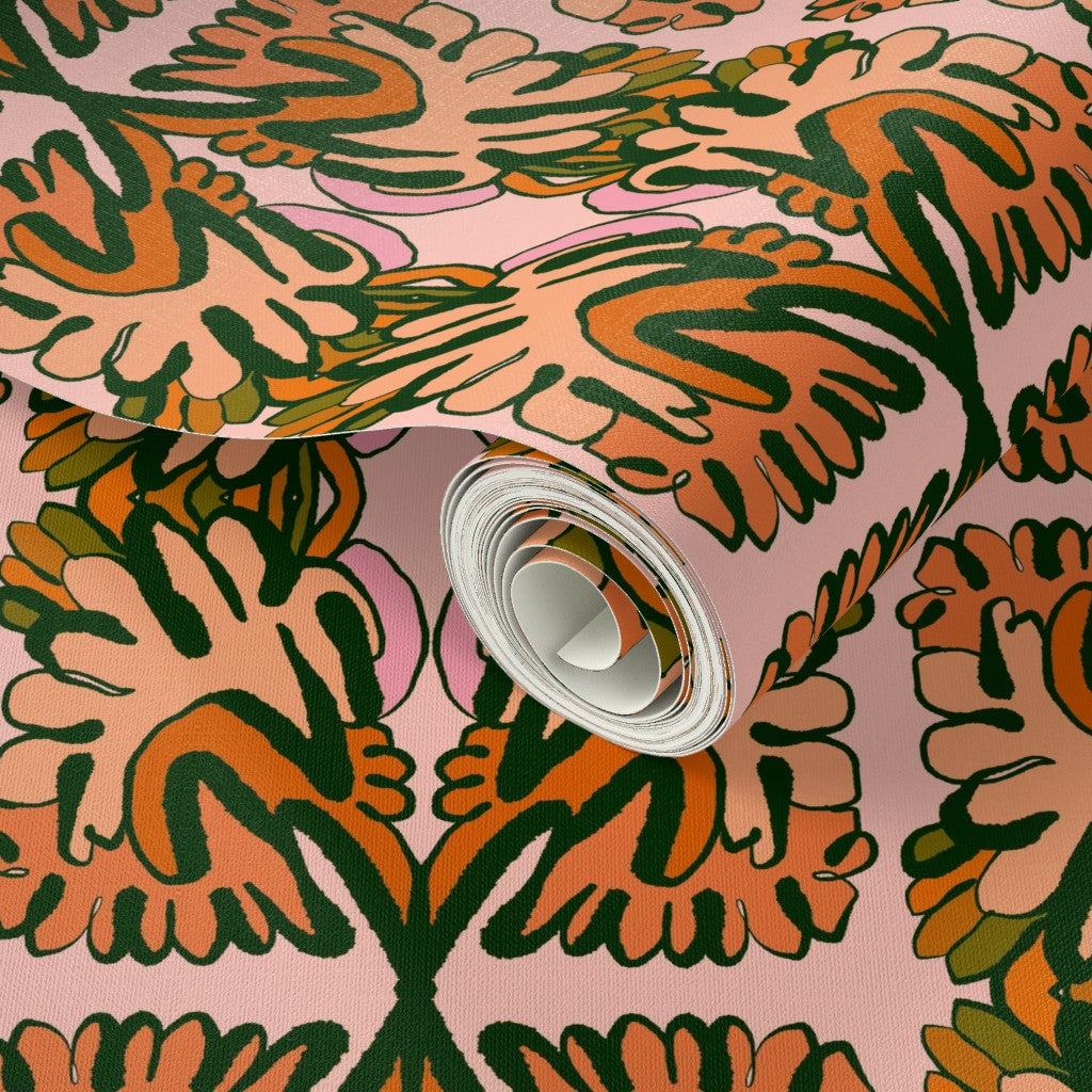 Roll of wallpaper with a colorful leaf pattern on a pink background. Designed by artist Leila Simon Hayes. 