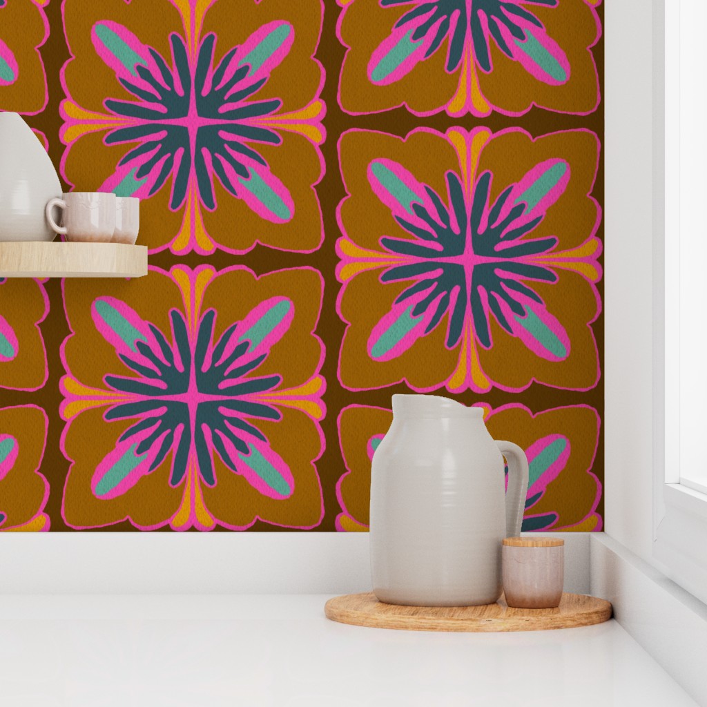 A retro-style floral wallpaper with a bold mid-century modern pattern in brown, orange, pink, and teal, shown on a kitchen wall behind a white ceramic pitcher and cup on a wooden tray. Designed by artist Leila Simon Hayes.