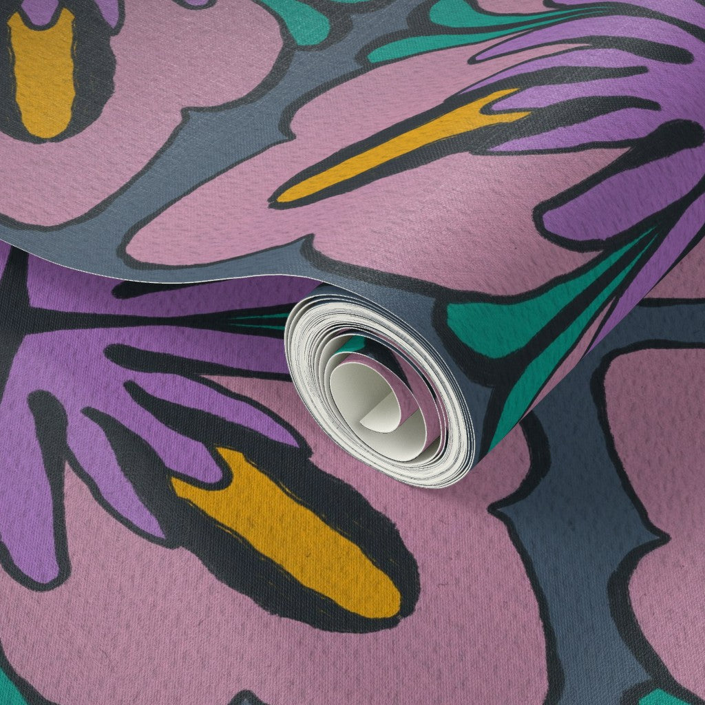 A close-up of a rolled sheet of patterned material, likely fabric, vinyl, or wallpaper, featuring an abstract floral design in pink, purple, teal, yellow, and dark gray/black. Designed by artist Leila Simon Hayes.