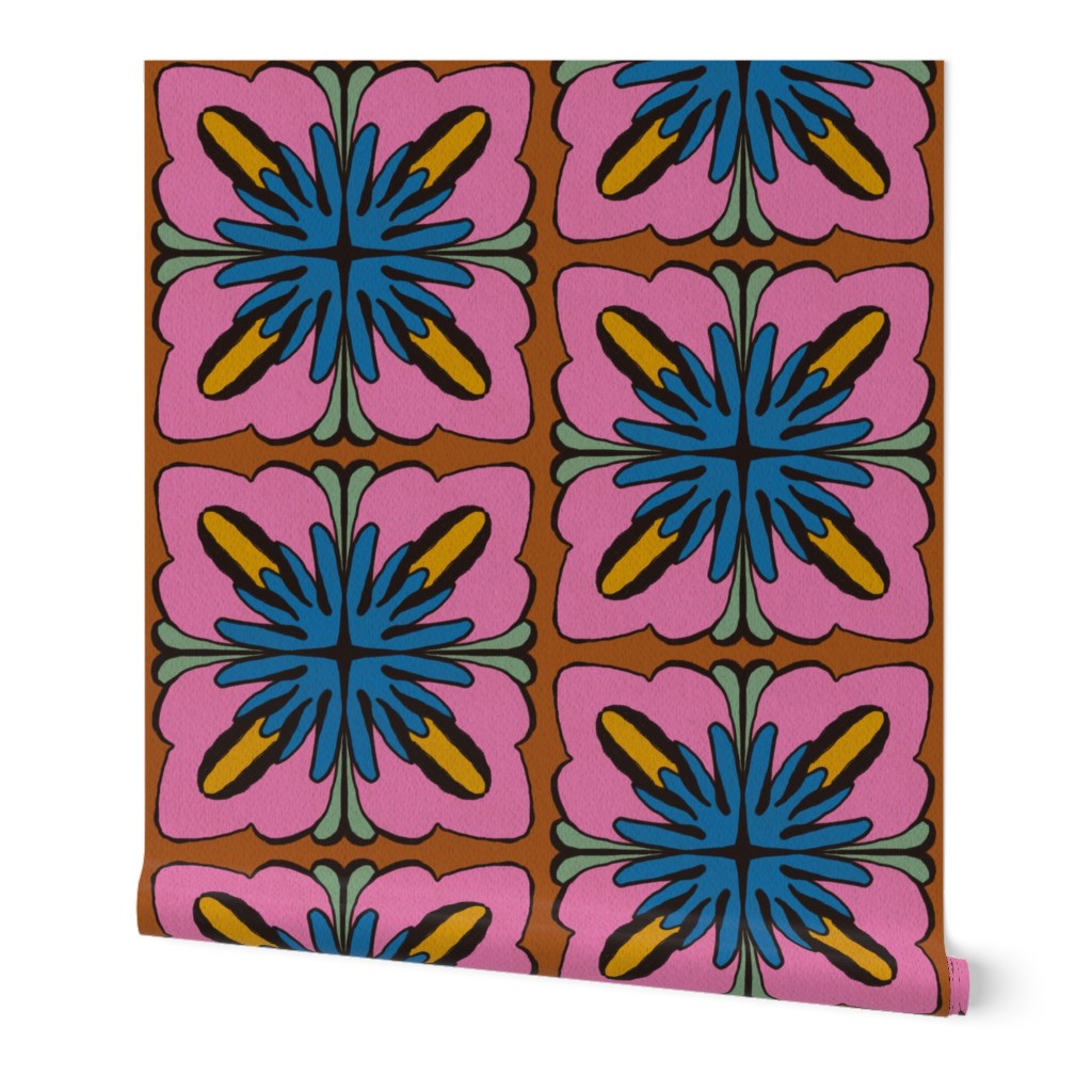 A roll of wallpaper featuring a retro 1970s floral pattern with pink petals, blue centers, yellow accents, and green leaves on a brown background, shown against a plain white backdrop. Designed by artist Leila Simon Hayes.