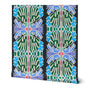 A wallpaper roll with geometric and floral-inspired pattern in green, blue, lavender, cream, and small pink accents on a dark background, shown against a plain white studio backdrop. Designed by artist Leila Simon Hayes.
