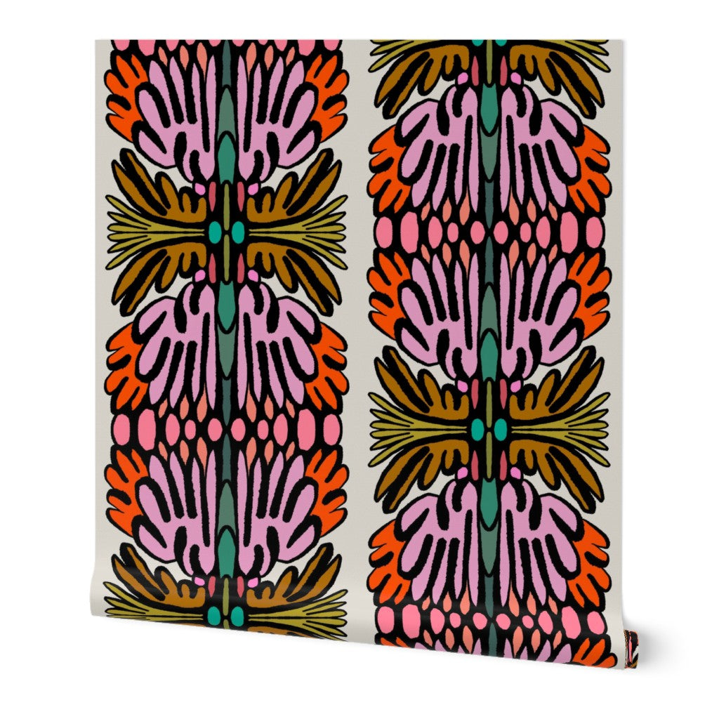 A roll of wallpaper featuring a bold, symmetrical mid-century modern pattern with pink, orange, teal, and olive green abstract leaf-like motifs on a cream background. Designed by artist Leila Simon Hayes.