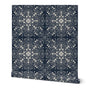 A roll of wallpaper featuring a dark navy blue background with a detailed, symmetrical cream-colored mandala and dot pattern, shown against a plain white background. Designed by artist Leila Simon Hayes.