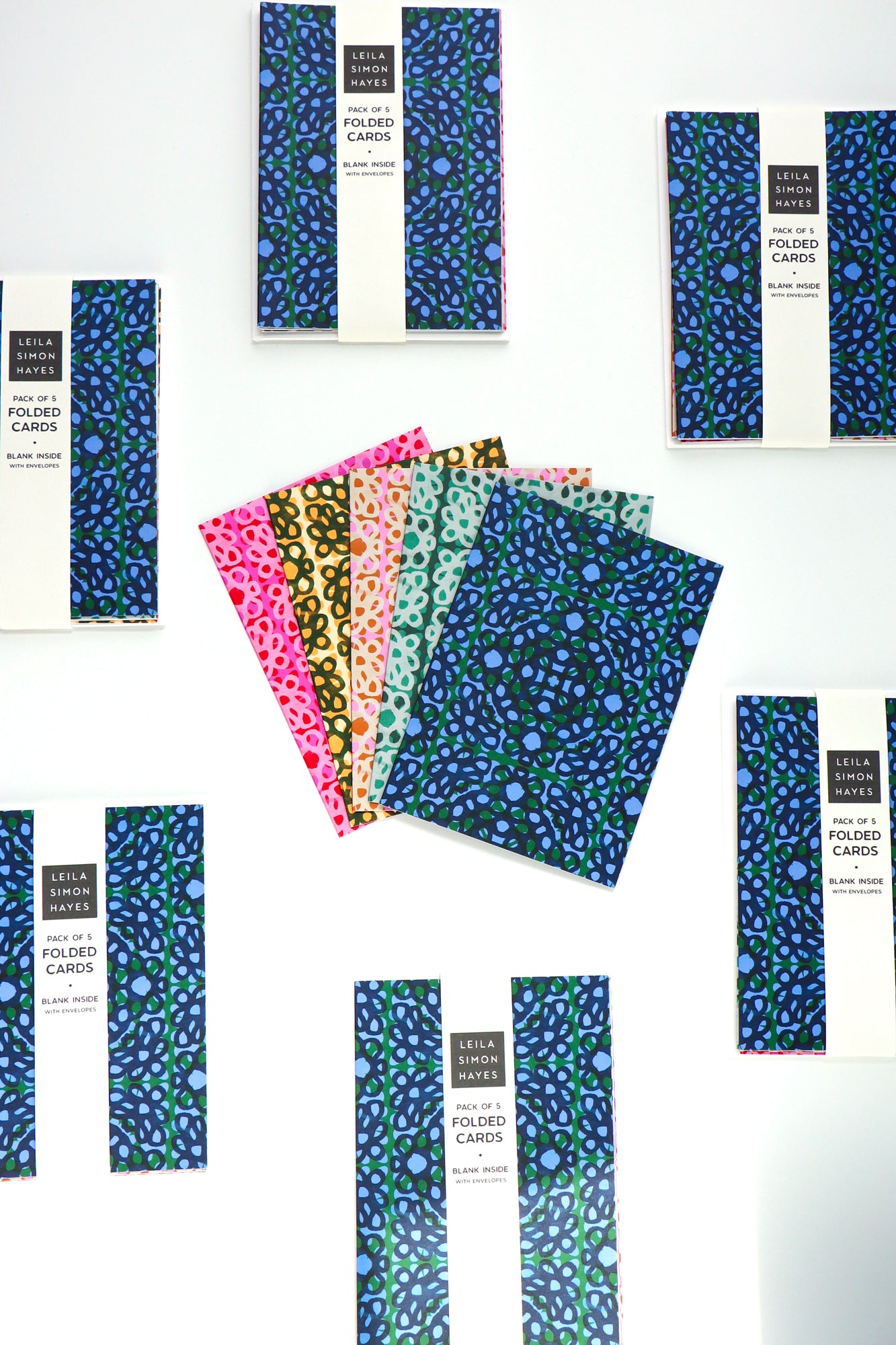 Pack of five lace loop patterned folded cards with a white envelope on a white background. Designed by artist Leila Simon Hayes.