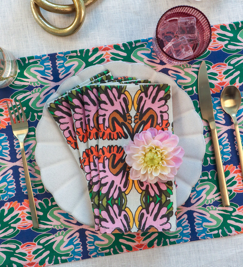 Designed by artist Leila Simon Hayes. Table setting with Flourish hand drawn design on dinner napkins and a placemat.