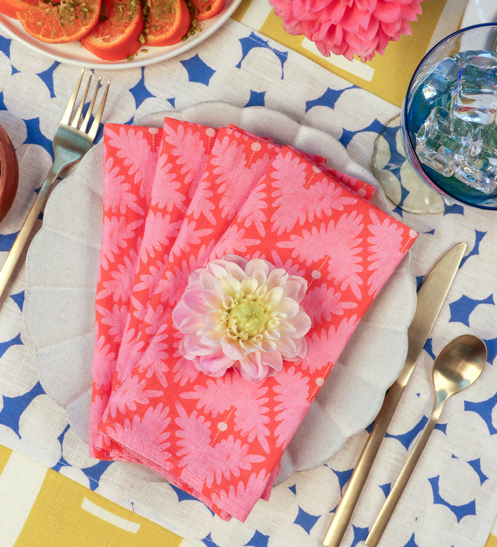 Designed by artist Leila Simon Hayes. Tablescape of mix match linens with colorful hand-drawn designs.