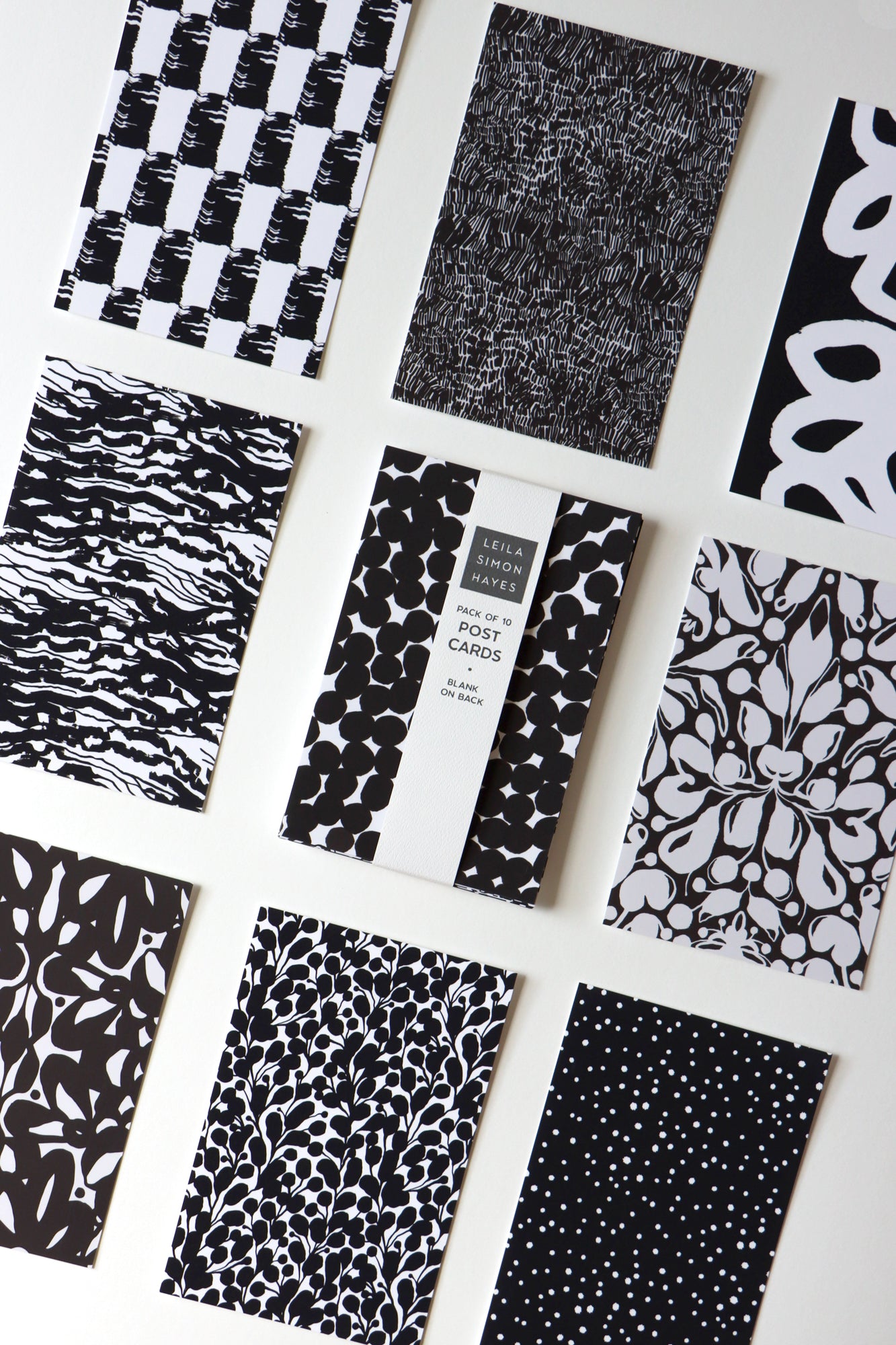 Collection of black and white patterned postcards on a white background, designed by artist Leila Simon Hayes.