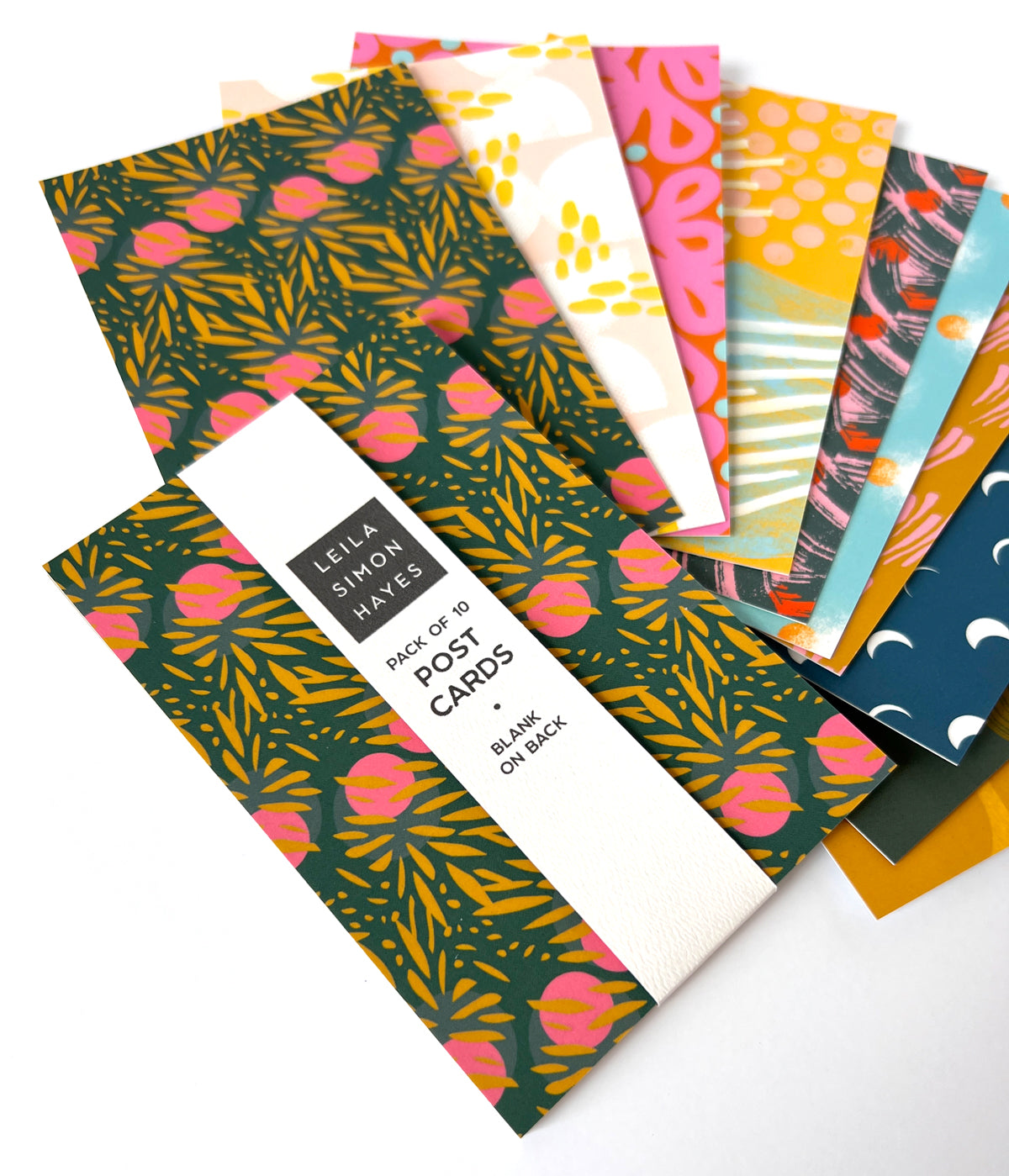 Set of 10 colorful postcards with a Leila Simon Hayes packaging label on a white background. Postcards are different patterns and floral designs. 