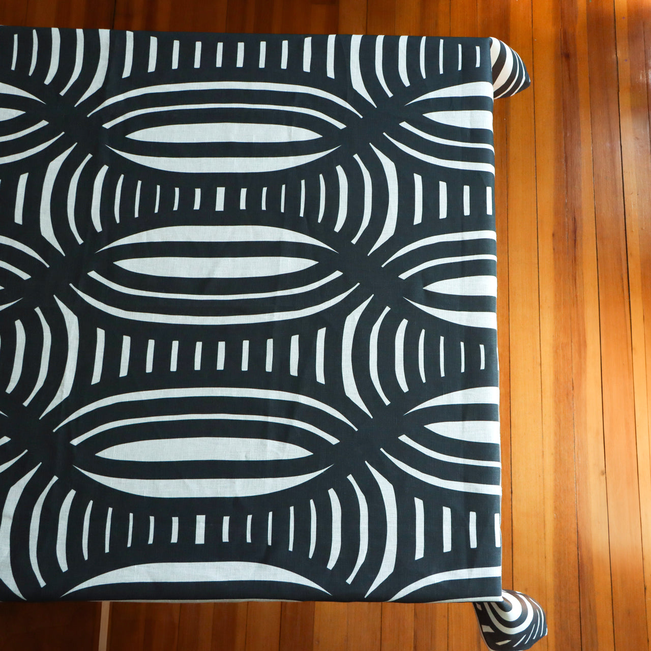 Black and white patterned tablecloth on a table. Designed by artist Leila Simon Hayes.