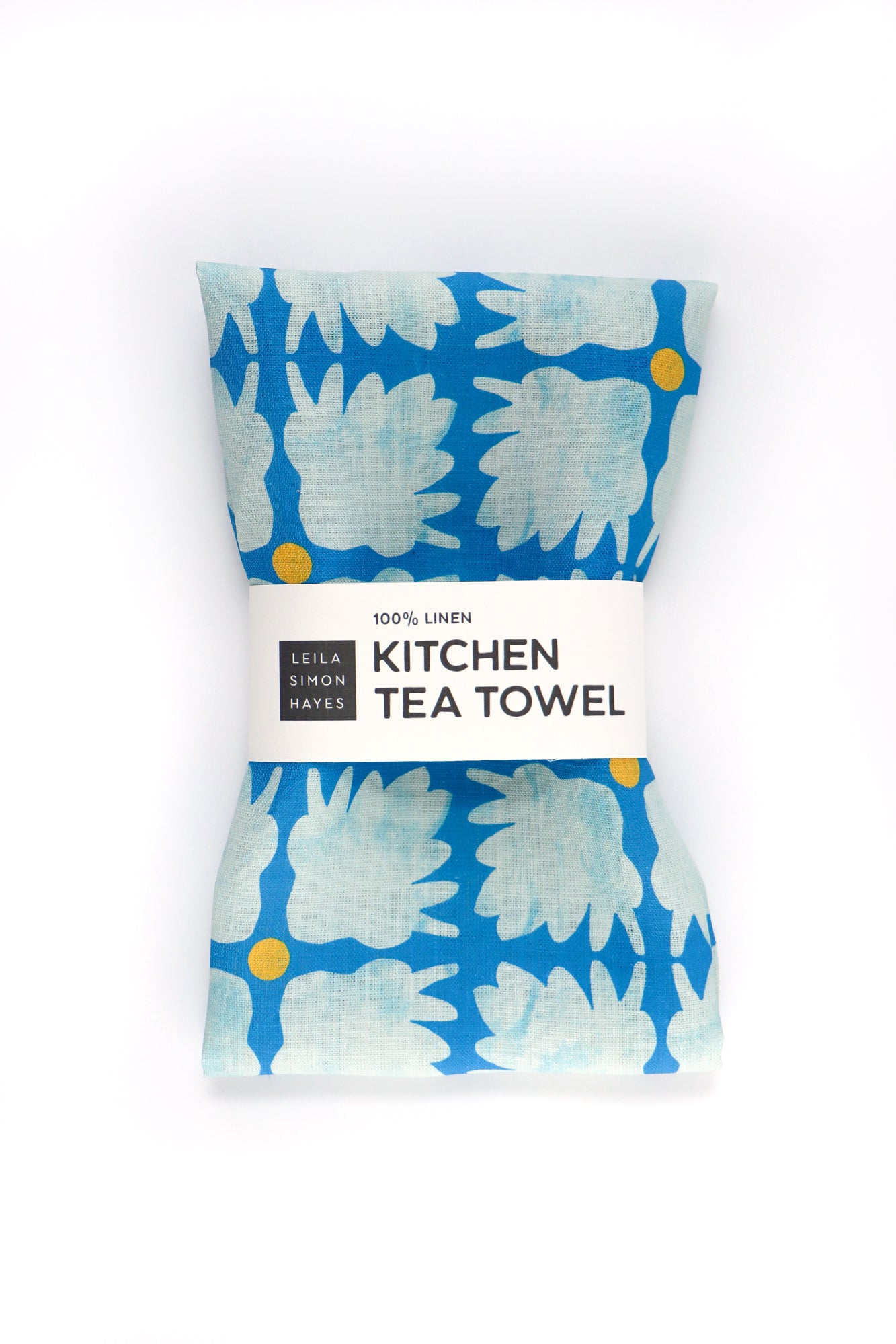 Kitchen tea towel with blue floral pattern on a white background. Designed by artist Leila Simon Hayes.