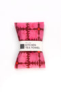 Kitchen tea towel with pink floral pattern on a white background. Designed by artist Leila Simon Hayes.