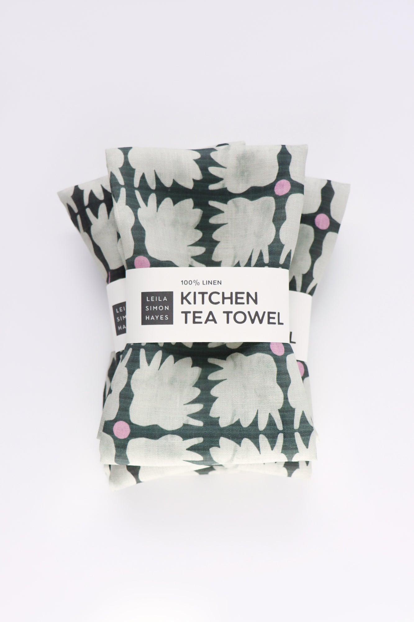 Packaged kitchen tea towels with floral pattern on a white background. Designed by artist Leila Simon Hayes.