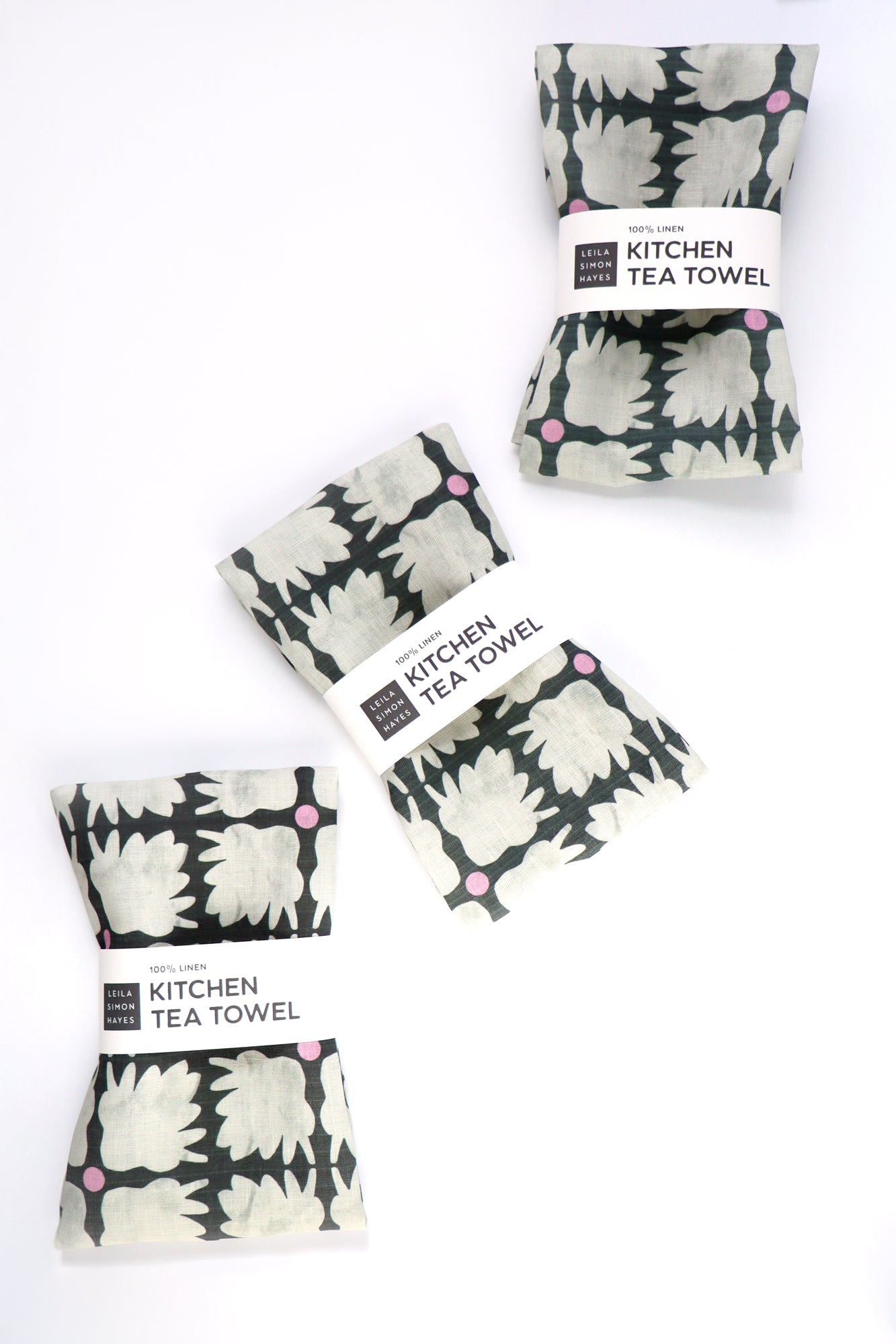Set of kitchen tea towels with floral pattern on a white background. Designed by artist Leila Simon Hayes.