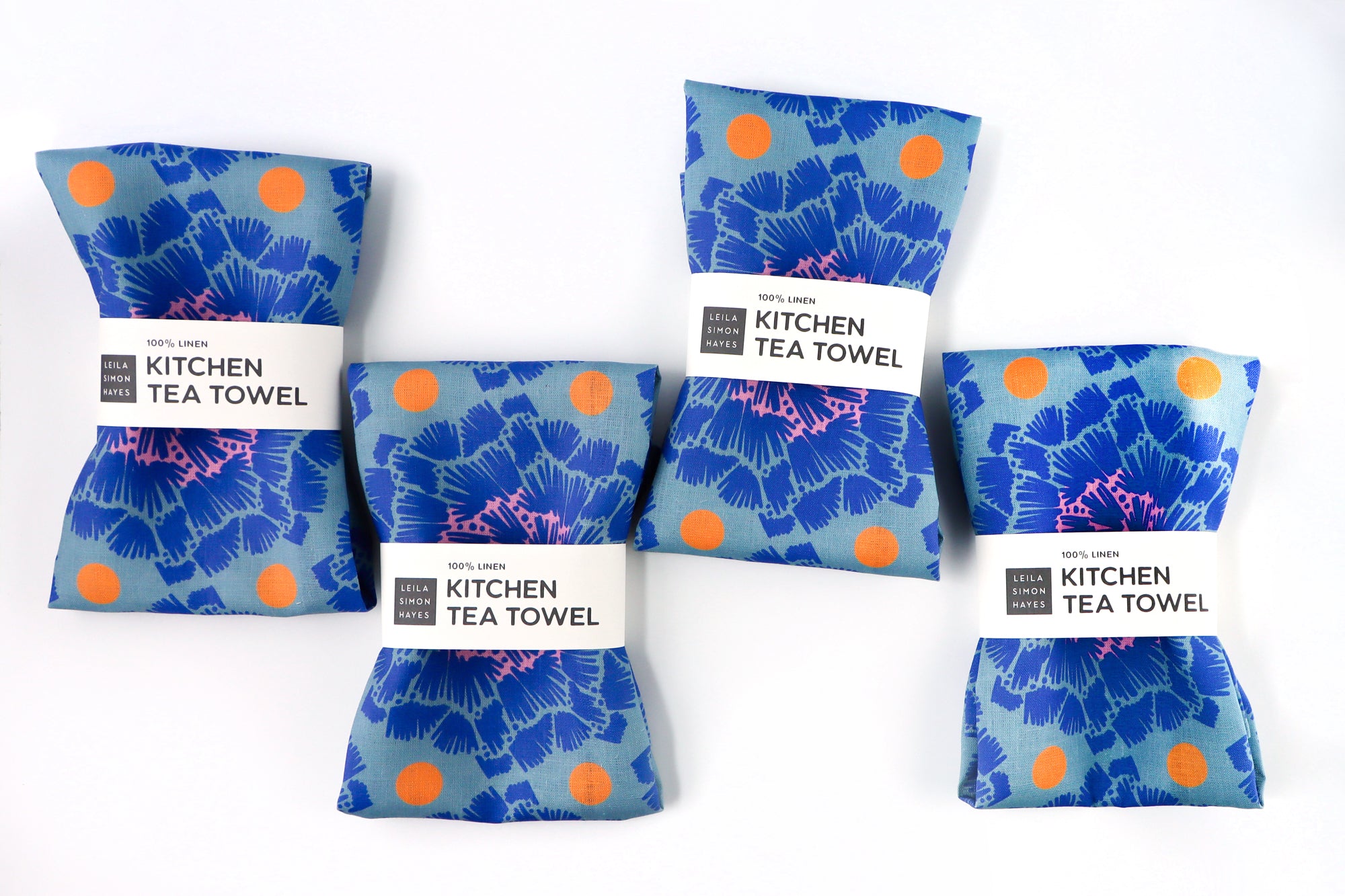Set of blue kitchen tea towels with orange dots on a white background. Designed by artist Leila Simon Hayes.