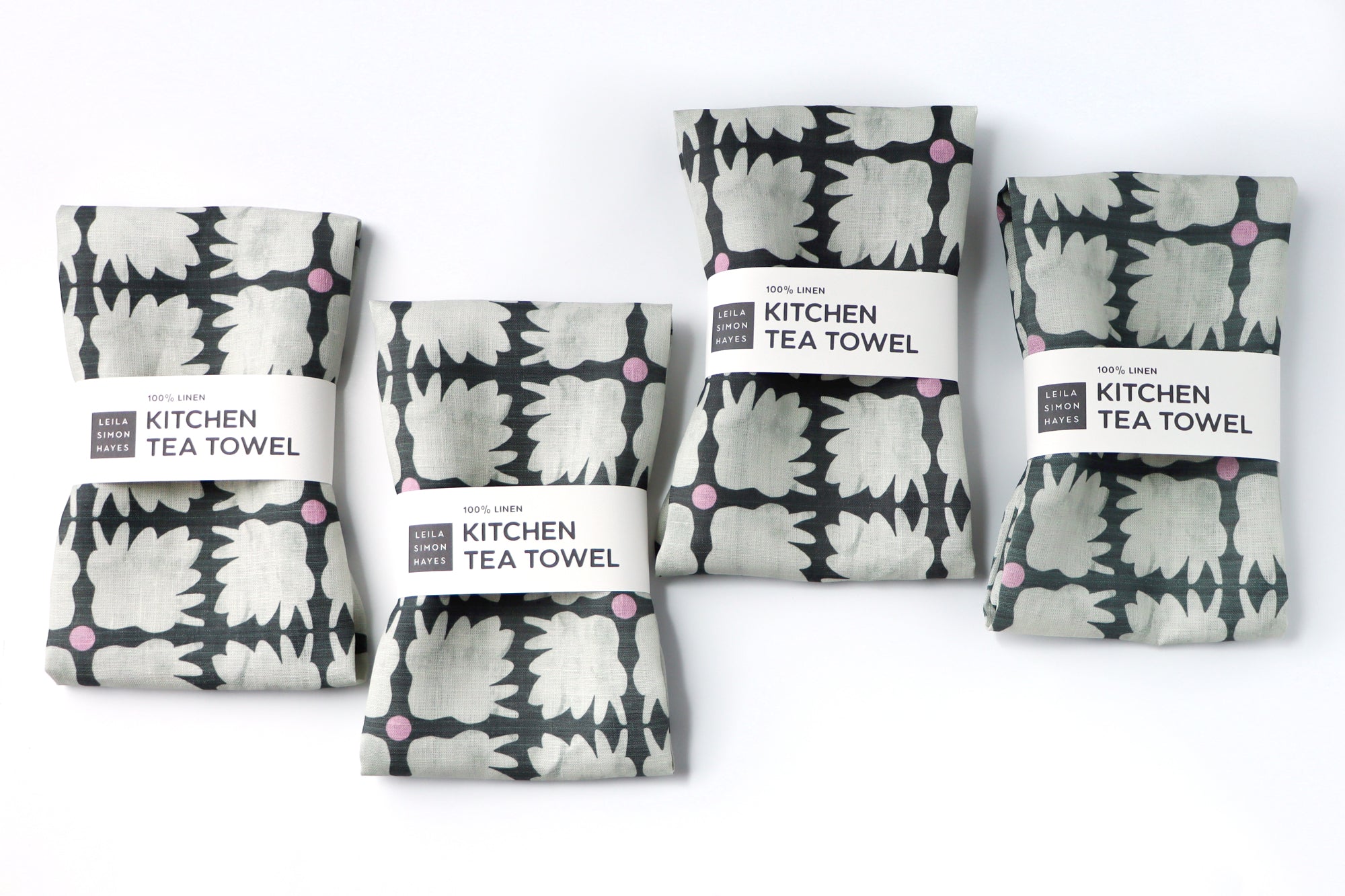 Set of kitchen tea towels with a geometric pattern on a white background. Designed by artist Leila Simon Hayes.