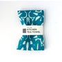 Blue kitchen tea towel with light blue pattern on a white background. Designed by artist Leila Simon Hayes.